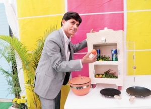 Manshuk Prajapati showing his clay refrigerator