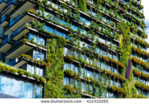 stock-photo-green-skyscraper-building-with-plants-growing-on-the-facade-ecology-and-green-living-in-city-412333285