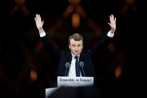 French President-elect Emmanuel Macron celebrates on the stage at his victory rally near the Louvre in Paris, France